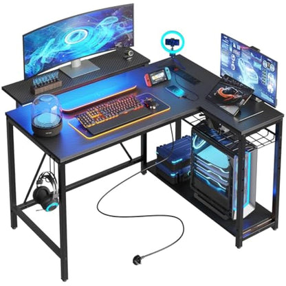 Bestier 106.5CM L-Shaped Gaming Desk with RGB LED Lights Carbon Fibre Surface, 3 Power Outlets & 2 USB Ports, Reversible Corner Desk with Shelves & Hooks for Home Office & Small Spaces