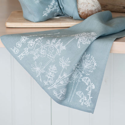 Helen Round Linen Tea Towel, duck egg blue. This beautiful, hand printed towel features garden flowers. Machine Washable at 40 degrees and will