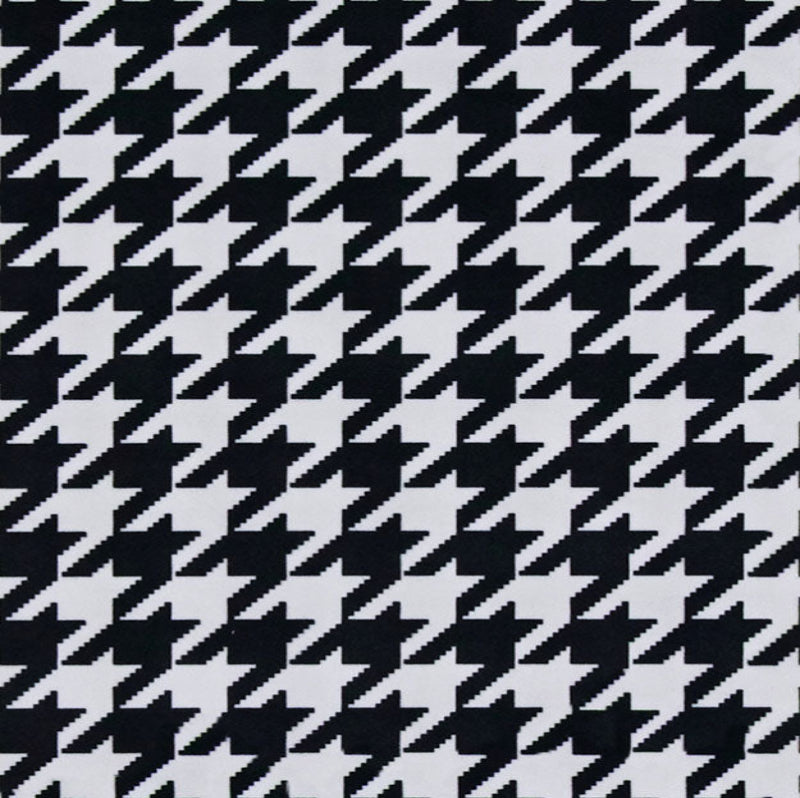 Houndstooth pattern in black and white on a gray background