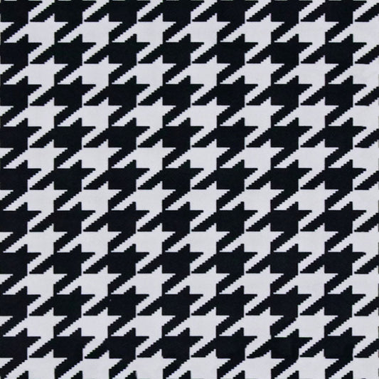 Houndstooth pattern in black and white on a gray background